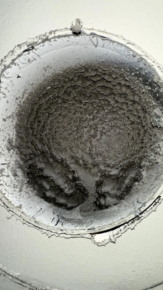 Dust and debris visible inside ductwork before cleaning